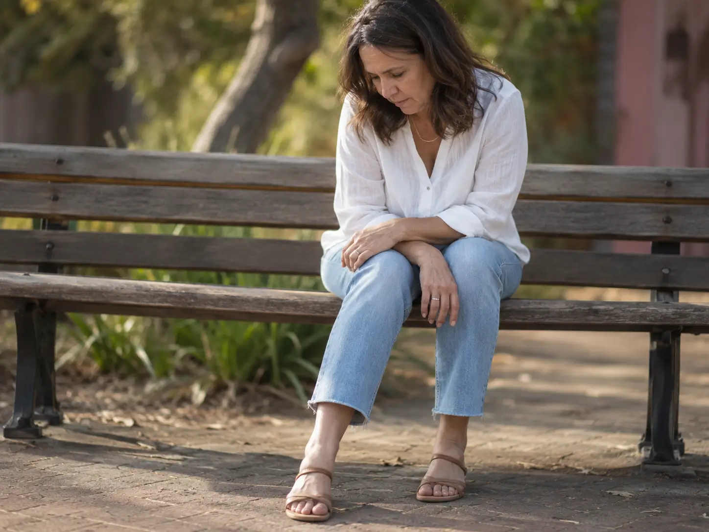 Susan sitting on a bench thinking about her condition
